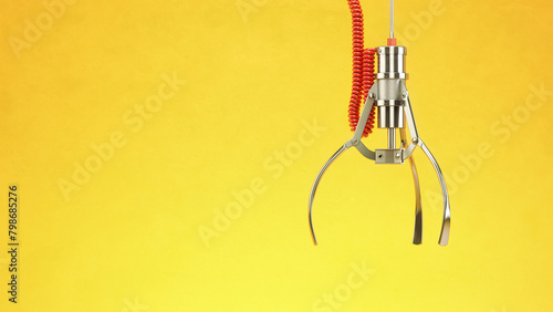 Fotografía Machine  claw on yellow background. Crane game.