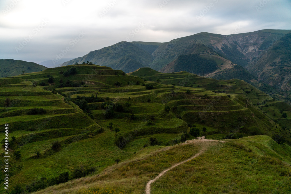 Obraz premium Chokhsky terraces Dagestan. Landscape of mountainous Dagestan with terraced fields and peaks mountains in the distance.