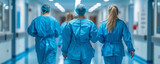 Healthcare workers in hazmat suits stride through a hospital corridor