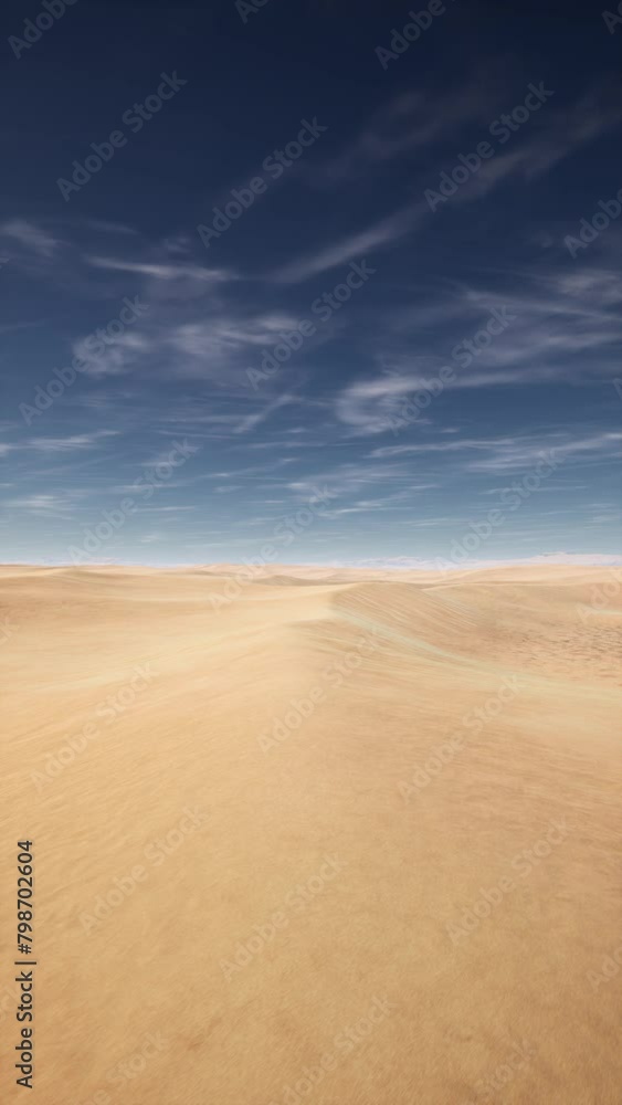 A desert plain under a blue sky filled with white clouds. A desert plain under a blue sky filled with white clouds.