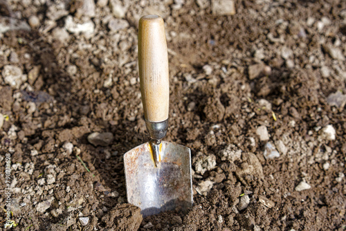 High angle view of small shovel gardening tool at vegetable bed of home garden at Swiss City of Zürich on a cloudy spring morning. Photo taken April 28th, 2024, Zurich, Switzerland.