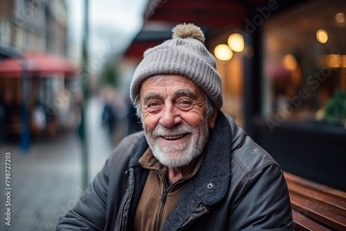 Portrait of an elderly man in a hat and jacket on the street