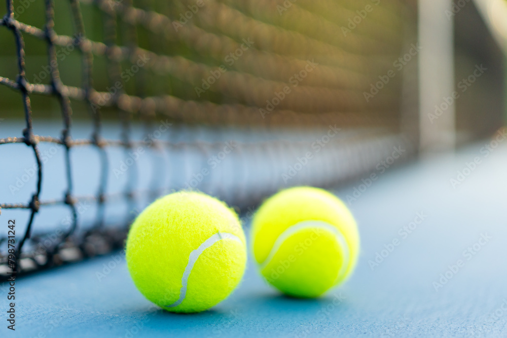 tennis balls near net on blue hard court, tennis compettion concept
