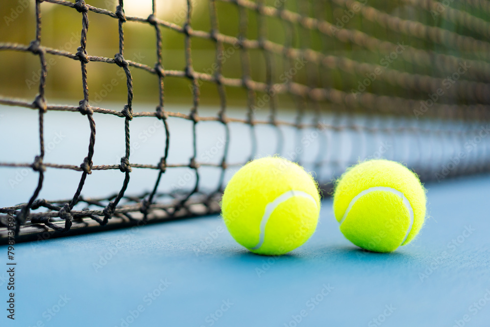 tennis balls near net on blue hard court, tennis compettion concept