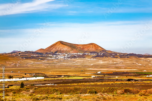 Volcanic landscape with a village, Island Lanzarote, Canary Islands, Spain, Europe.