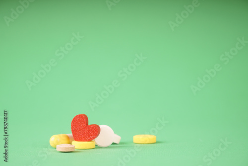 Heart and pills, a photo symbolizing medical treatment of the heart. Help with heart pain
