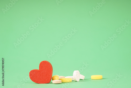 Heart and pills, a photo symbolizing medical treatment of the heart. Help with heart pain
