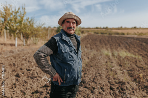 Portrait of Seasoned Wisdom Elderly Farmer in Agricultural Field © Alexandr