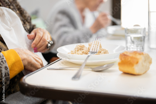 Close up of an elderly woman having lunch at retirement home. High quality photo