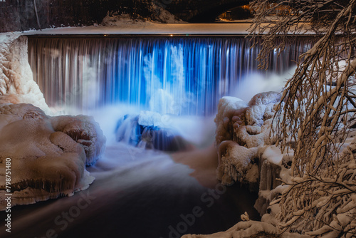 Small waterfall in winter lit up in blue and white for Finnish independence day, Helsinki Finland