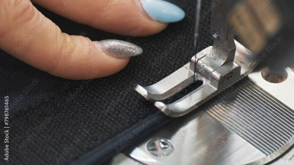 This stock video shows the hands of a seamstress who is sewing a Velcro fastener to the fabric on a sewing machine. This stock video will decorate your projects related to industry, sewing. This stock video shows the hands of a seamstress who is sewing a Velcro fastener to the fabric on a sewing machine. This stock video will decorate your projects related to industry, sewing.