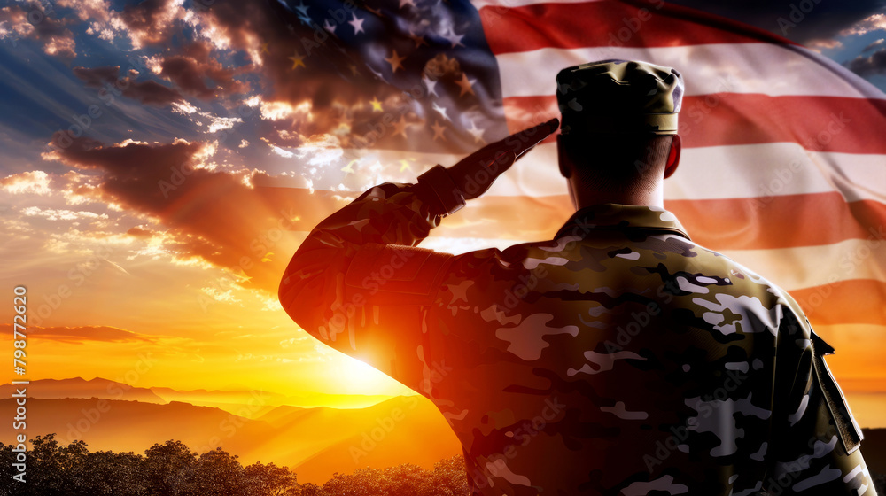 Silhouette of a US army soldier saluting the American flag during a vibrant sunset