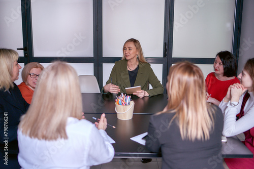 the female boss speaks kindly to her subordinates at the meeting