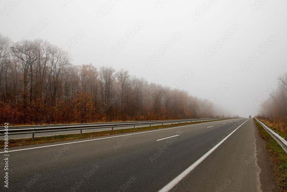 Foggy autumn deserted asphalt road. minimalism Foggy autumn deserted asphalt road. minimalism