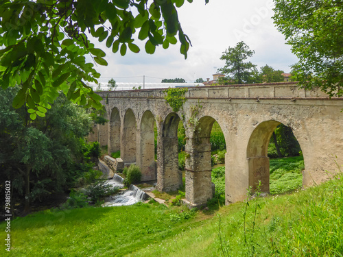 Photos Panoramic view of hidden unknown ancient old Roman Aqueduct Ponte Aquedotto del 1700 - 1734 in the village of Busca, Cuneo province, Piedmont, Italy