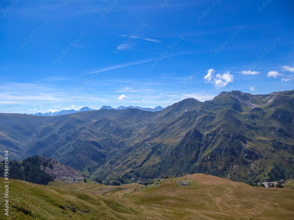 Panoramic mountain landscape of Cottian Alps in Grana Valley (Valle Grana) with clear blue sky on a sunny summer day, Castelmagno, Cuneo, Piedmont, Italy. Alpine pasture of Western Italian Alps
