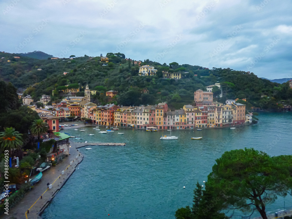Aerial view of coastal port town of Portofino at the Ligurian Mediterranean Sea, Italy, Europe. Lucury yachts and boats in the small harbor. Overcast during winter season. Travel destination