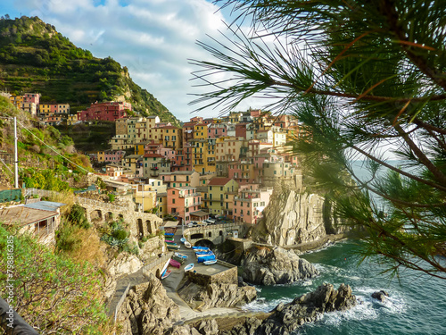 Scenic view of the small fishermen town of Manarola in Cinque Terre, Liguria, Italy, Europe. Squeezed between two steep terraced hills that descend to the sea in steep crags. Colorful houses photo