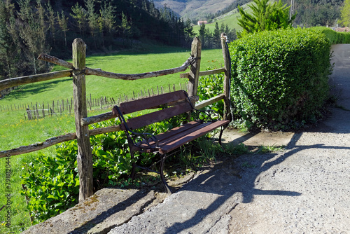 Wooden bench by the road in a rural area