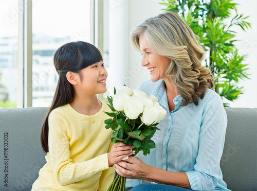 Grandmother receives flowers from her granddaughter, mother's day,