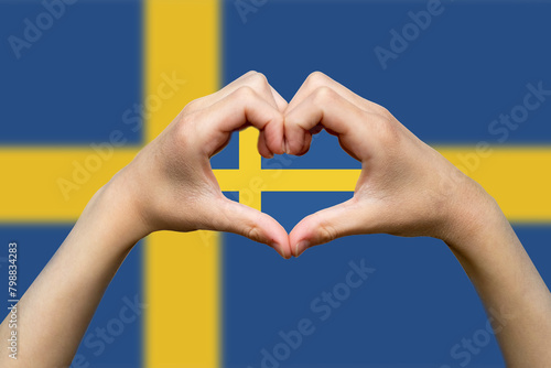 Sweden flag with two hands heart shape, express love or affection concept, vector design, support 