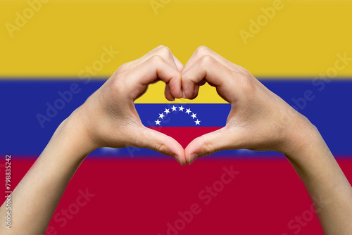 Venezuela flag with two hands heart shape, patriotism and nationalism idea, support or donate to 