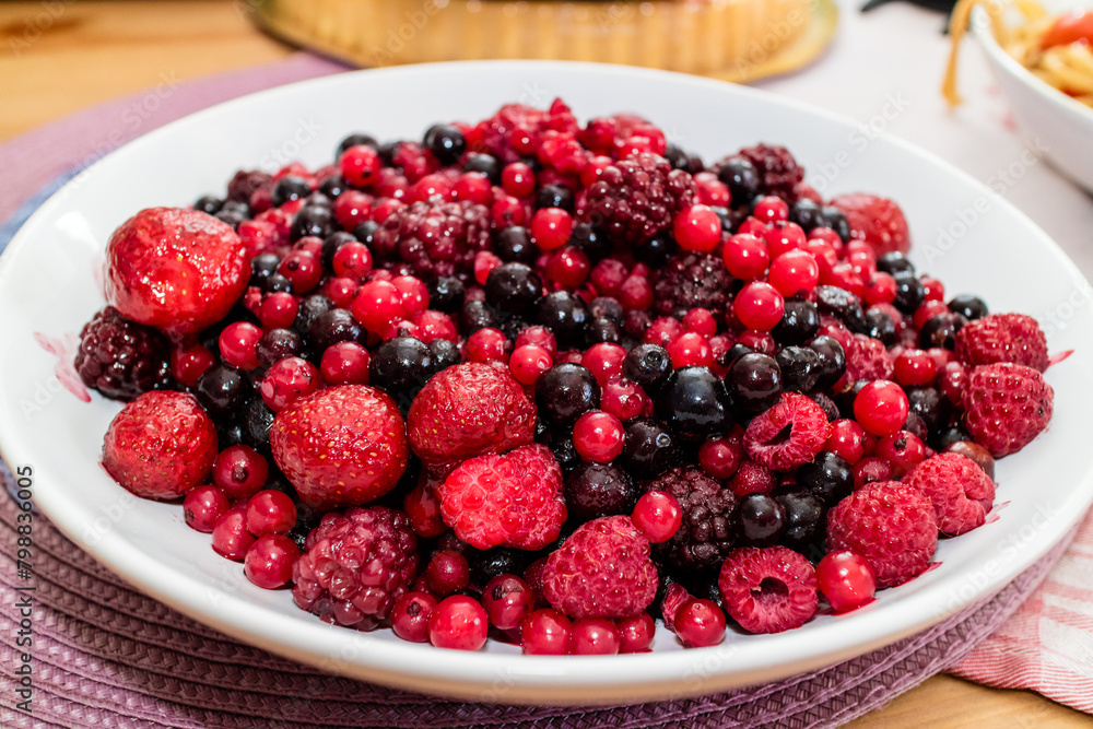 Assortment of Fresh Forest Berries on a Rustic Wooden Surface Assortment of Fresh Forest Berries on a Rustic Wooden Surface