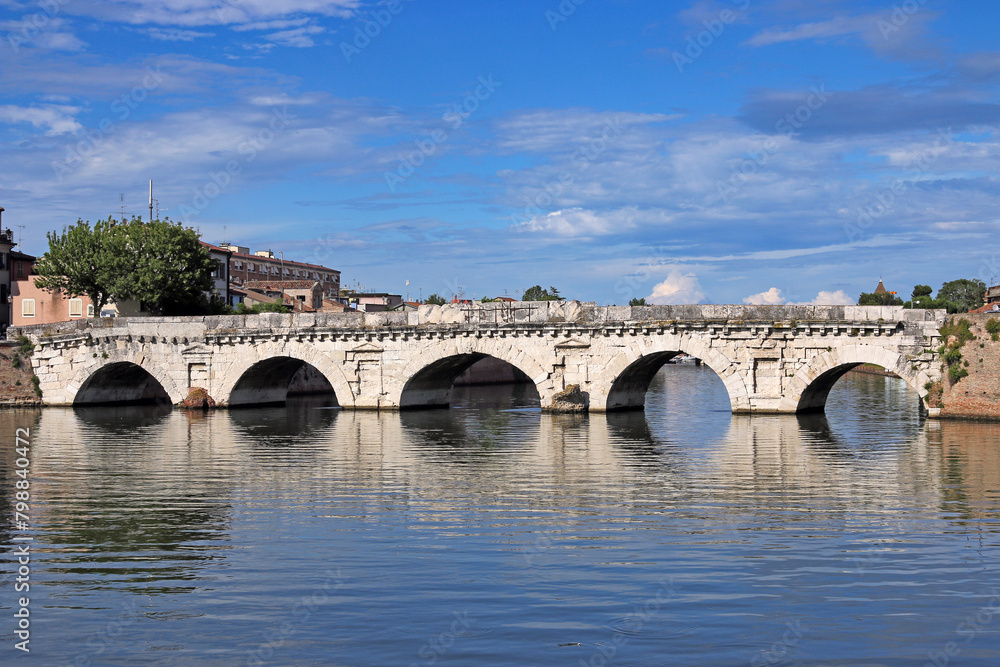 Old stone Tiberius bridge in Rimini Italy summer season Old stone Tiberius bridge in Rimini Italy summer season