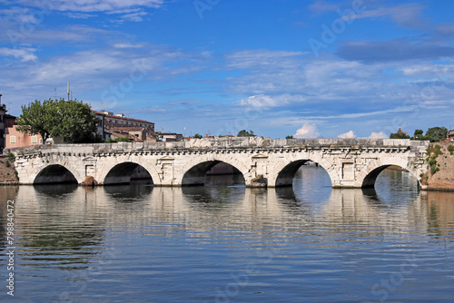 Old stone Tiberius bridge in Rimini Italy summer season