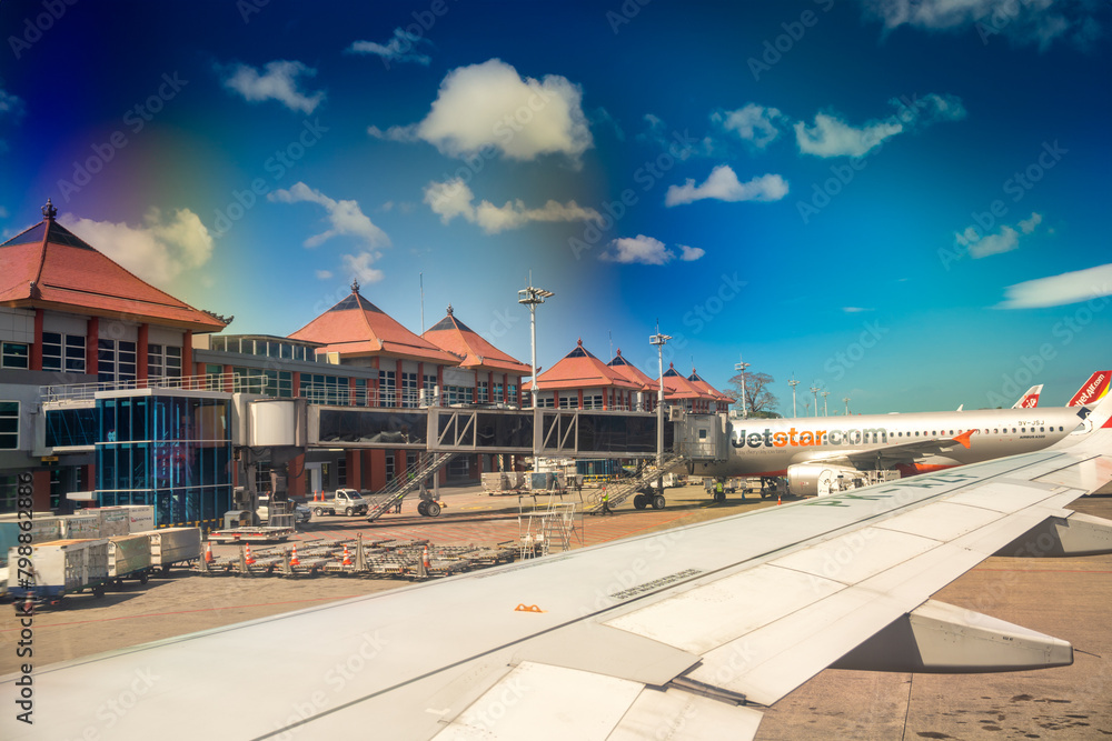 Bali, Indonesia - August 30, 2023: Airplanes along the Ngurah Rai International Airport runway in Denpasar