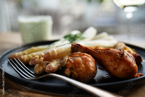 Fresh white asparagus with crispy chicken legs. Background for healthy eating concept with space for text