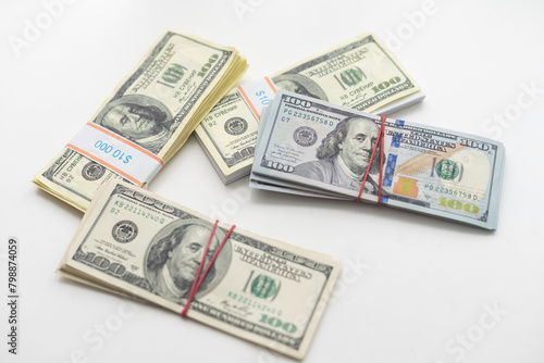 roles dollar notes in front of white background