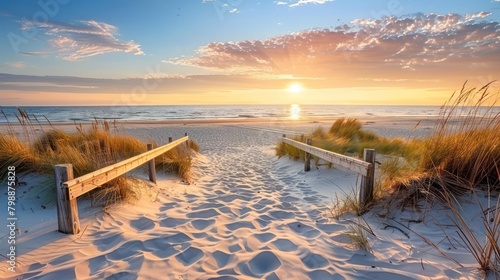 Beautiful sand dune beach at sunset with wooden bridge