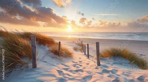 Beautiful sand dune beach at sunset with wooden bridge