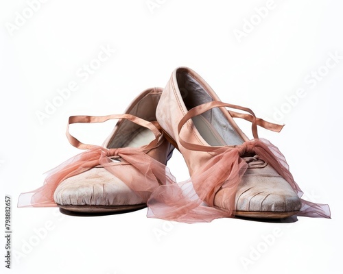 A pair of old ballet slippers with pink ribbons