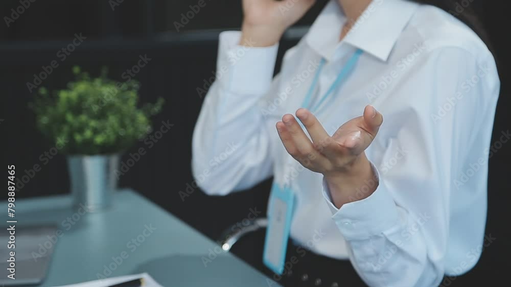 Asian businesswoman in formal suit in office happy and cheerful during using smartphone and working Asian businesswoman in formal suit in office happy and cheerful during using smartphone and working