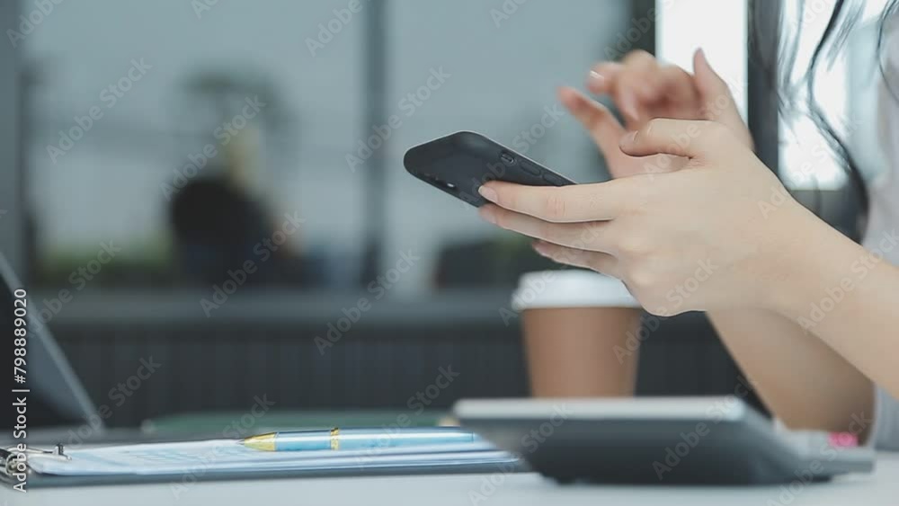 Asian businesswoman in formal suit in office happy and cheerful during using smartphone and working Asian businesswoman in formal suit in office happy and cheerful during using smartphone and working