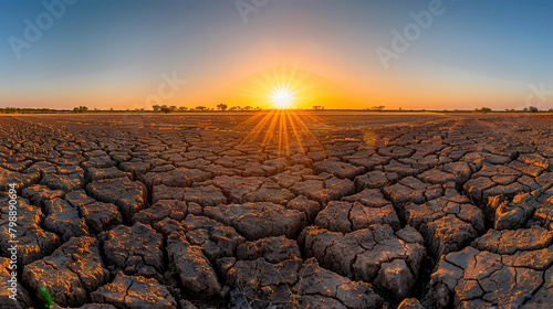 Under scorching sunlight, parched land bears witness to the harsh realities of global warming and escalating climate change. photo