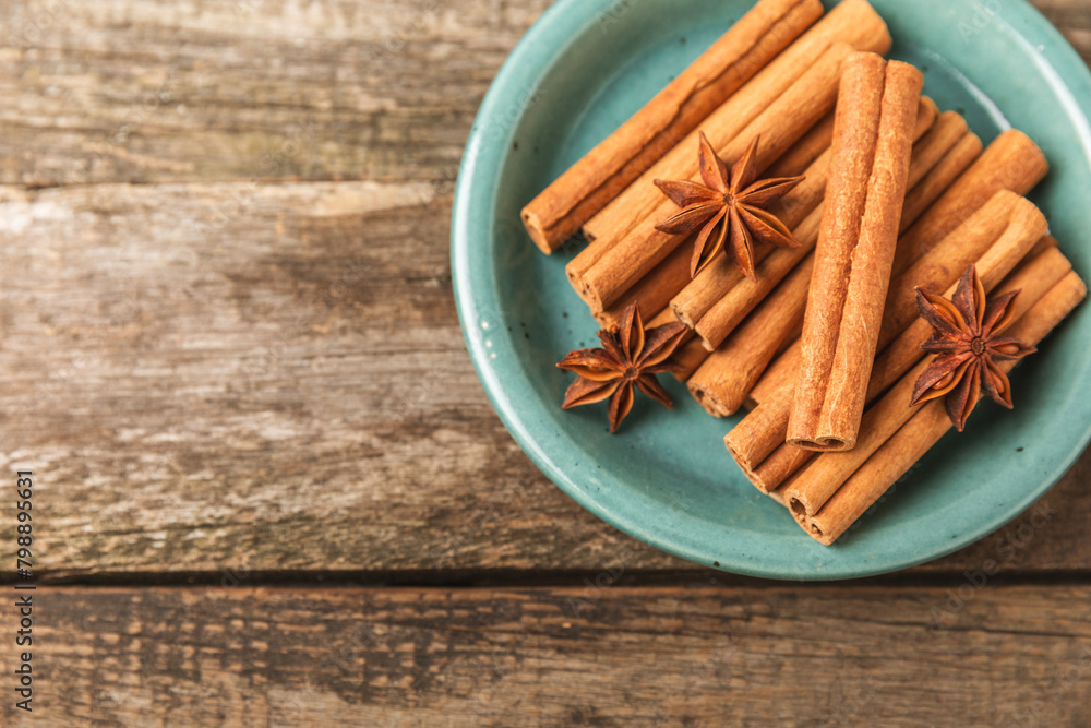 Cinnamon sticks and anise on a textured background. Cinnamon roll and star anise. Spicy spice for baking, desserts and drinks. Fragrant ground cinnamon.Place for text. copy space. Cinnamon sticks and anise on a textured background. Cinnamon roll and star anise. Spicy spice for baking, desserts and drinks. Fragrant ground cinnamon.Place for text. copy space.