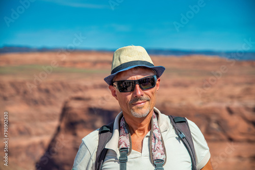 A man visiting the famous Horseshoe Bend Canyon on a summer day © jovannig