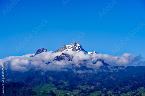 Scenic view of famous snow covered Pilauts mountain seen from Swiss village of Kehrsiten on a sunny spring day. Photo taken April 11th, 2024, Kehrsiten, Canton Nidwalden, Switzerland.