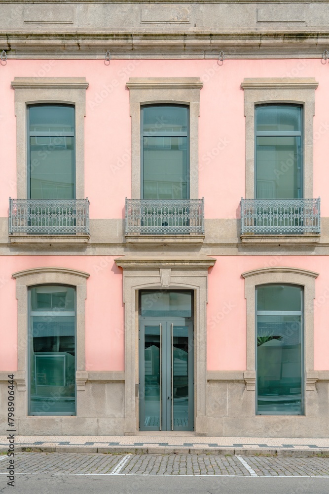 Colorful pink facade of an old house in Porto, Portugal. Porto is one of the most popular tourist destinations in Europe.