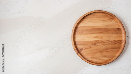 Empty wooden round board on white stone kitchen table top view photo