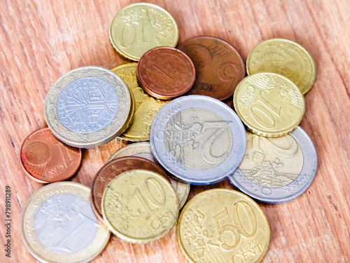 Economic Indicators. Scattered Euro coins, representing economic indicators. Uses for Market analysis reports, financial forecasting.