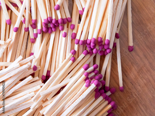 Striking Matches. Matches with purple tips, scattered arrangement. Uses for Product packaging, creative projects.