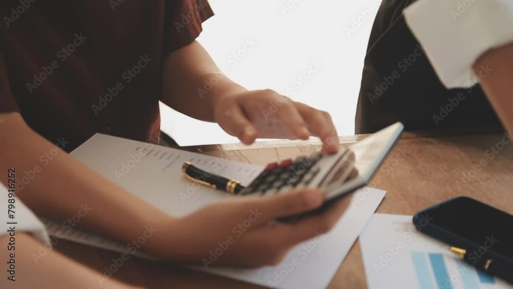 Financial analysts analyze business financial reports on a digital tablet planning investment project during a discussion at a meeting of corporate showing the results of their successful teamwork. Financial analysts analyze business financial reports on a digital tablet planning investment project during a discussion at a meeting of corporate showing the results of their successful teamwork.
