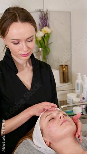 An experienced cosmetologist massage therapist performs a relaxing facial massage for the client to relieve tension, promoting deep relaxation and hydration, leaving your skin refreshed and radiant.
