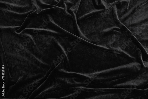 Texture of black velour fabric, top view. A noble dark shade with rich drape and a smooth texture with a beautiful matte sheen. background texture, pattern.