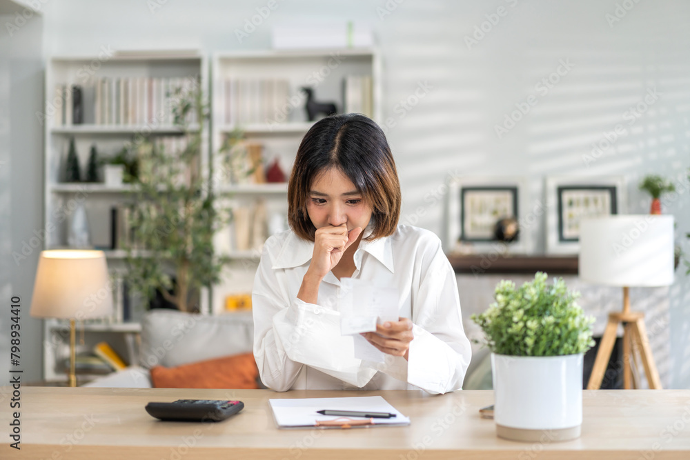 Smiling asian woman using calculator and calculate bills on laptop, paying bill, credit card, finance, tax, vat, credit card, payment, tax refund, budget, debt, money.financial and accounting concept Smiling asian woman using calculator and calculate bills on laptop, paying bill, credit card, finance, tax, vat, credit card, payment, tax refund, budget, debt, money.financial and accounting concept