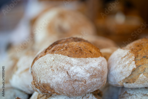 Bakery stall at medieval fair in France. Proud baker behind the counter.